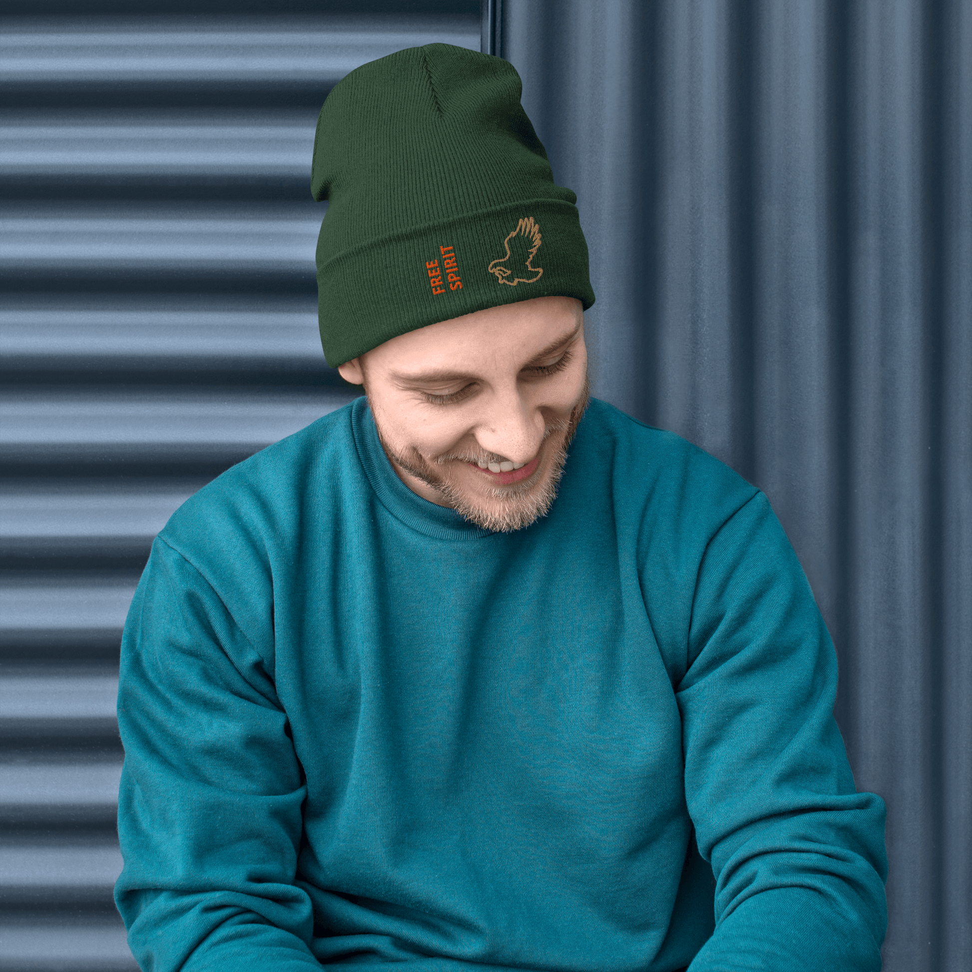 Eagle Beanie – Embroidered Knit Hat with Custom Text worn by a smiling man in a green sweater, showing the embroidered eagle design.