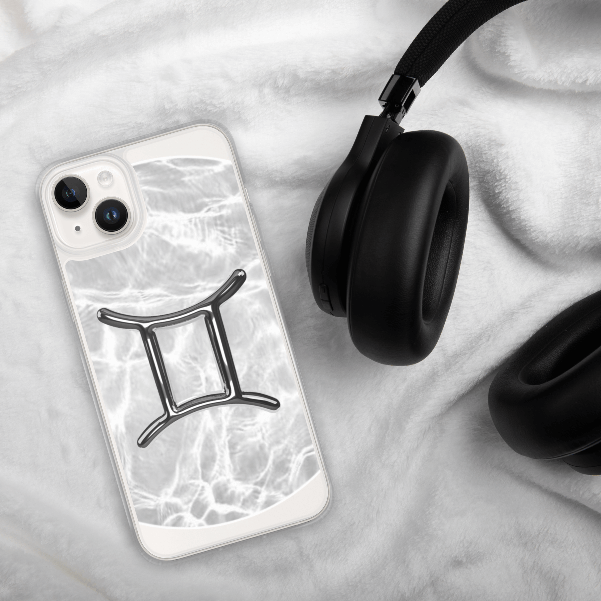 Zodiac Gemini Magsafe clear iPhone case on soft fur with headphones, featuring marble metallic design.