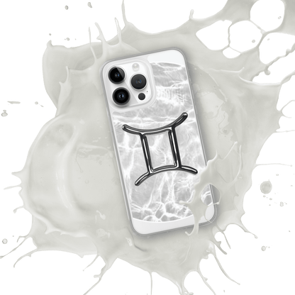 Gemini MagSafe clear iPhone case with metallic design over a marble ripple, splashed in white.