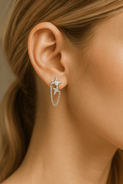 Gold Star Chain Earrings with Zirconia Sparkle and Celestial Charm worn by a model.