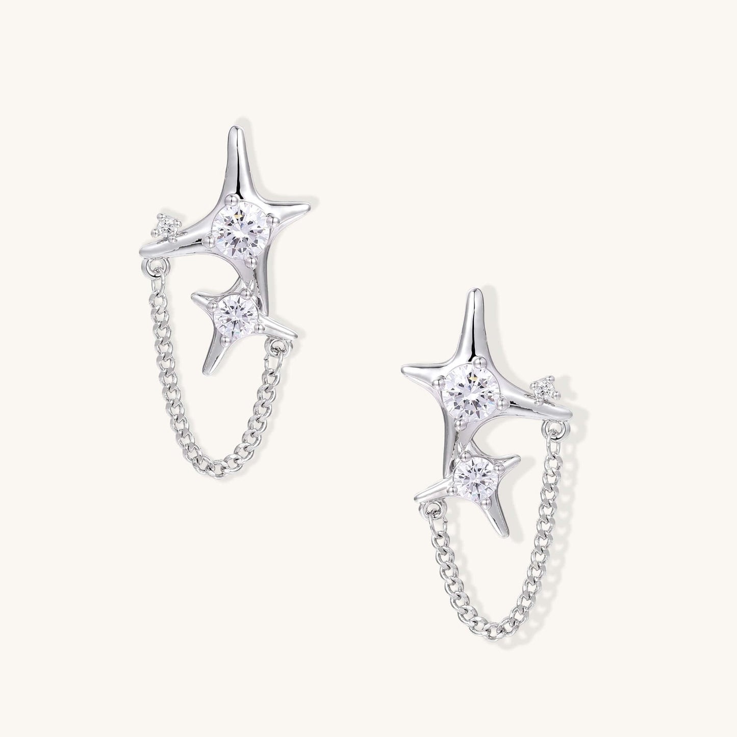 Gold Star Chain Earrings with Zirconia Sparkle and Celestial Charm featuring double star studs and delicate chain.