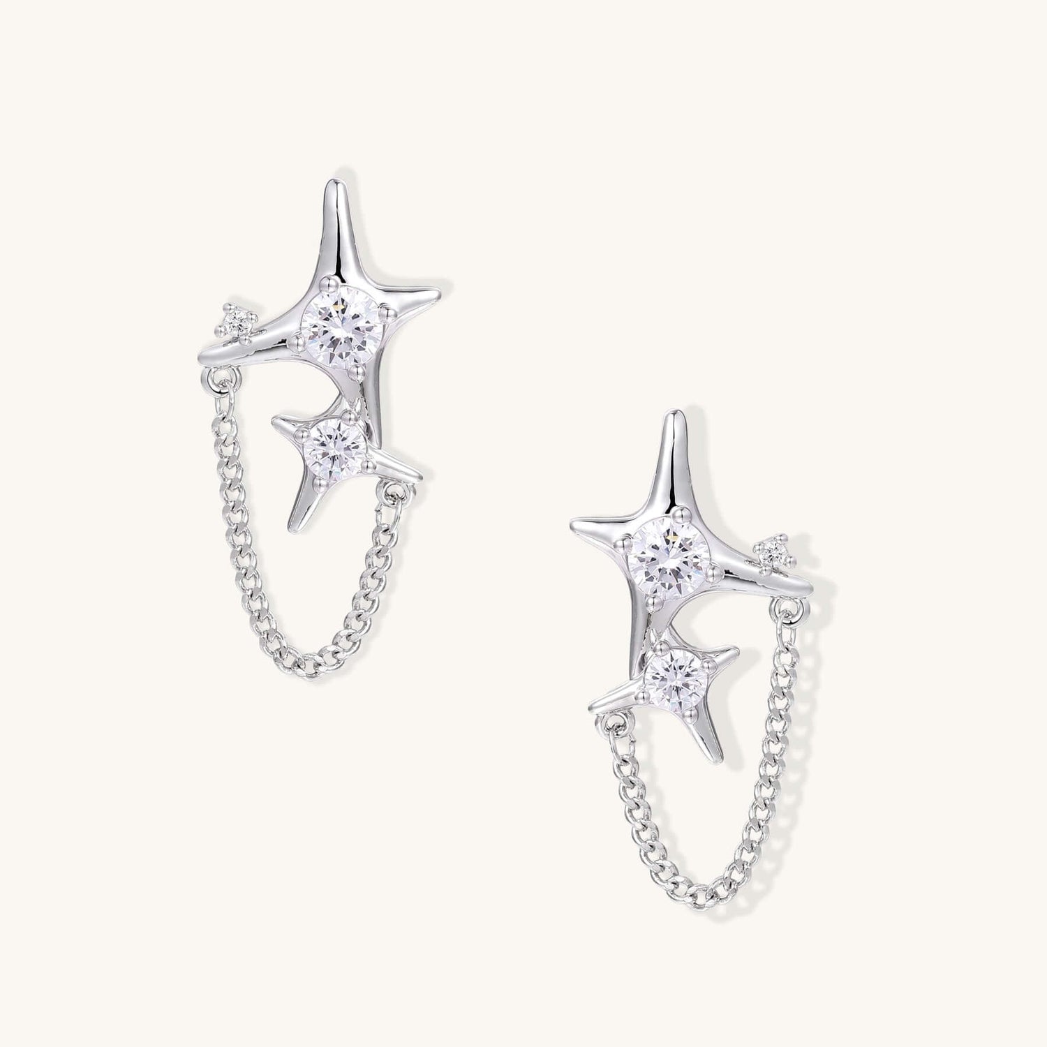 Gold Star Chain Earrings with Zirconia Sparkle and Celestial Charm featuring double star studs and delicate chain.