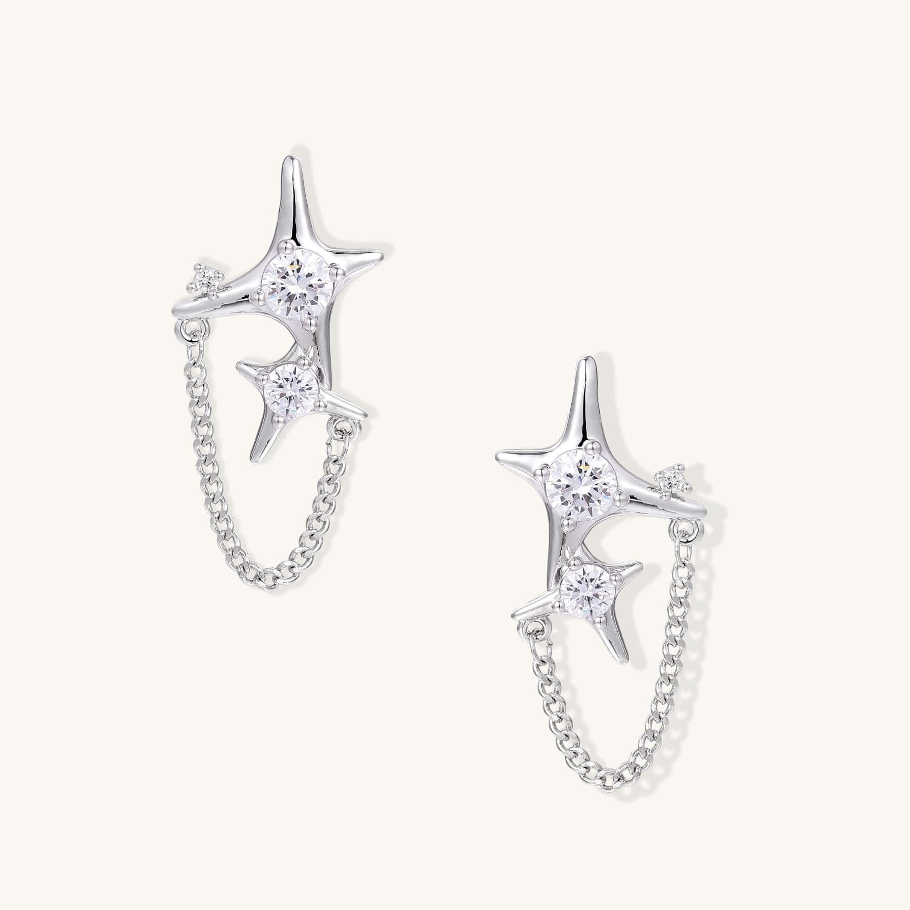 Gold Star Chain Earrings with Zirconia Sparkle and Celestial Charm featuring double star studs and delicate chain.