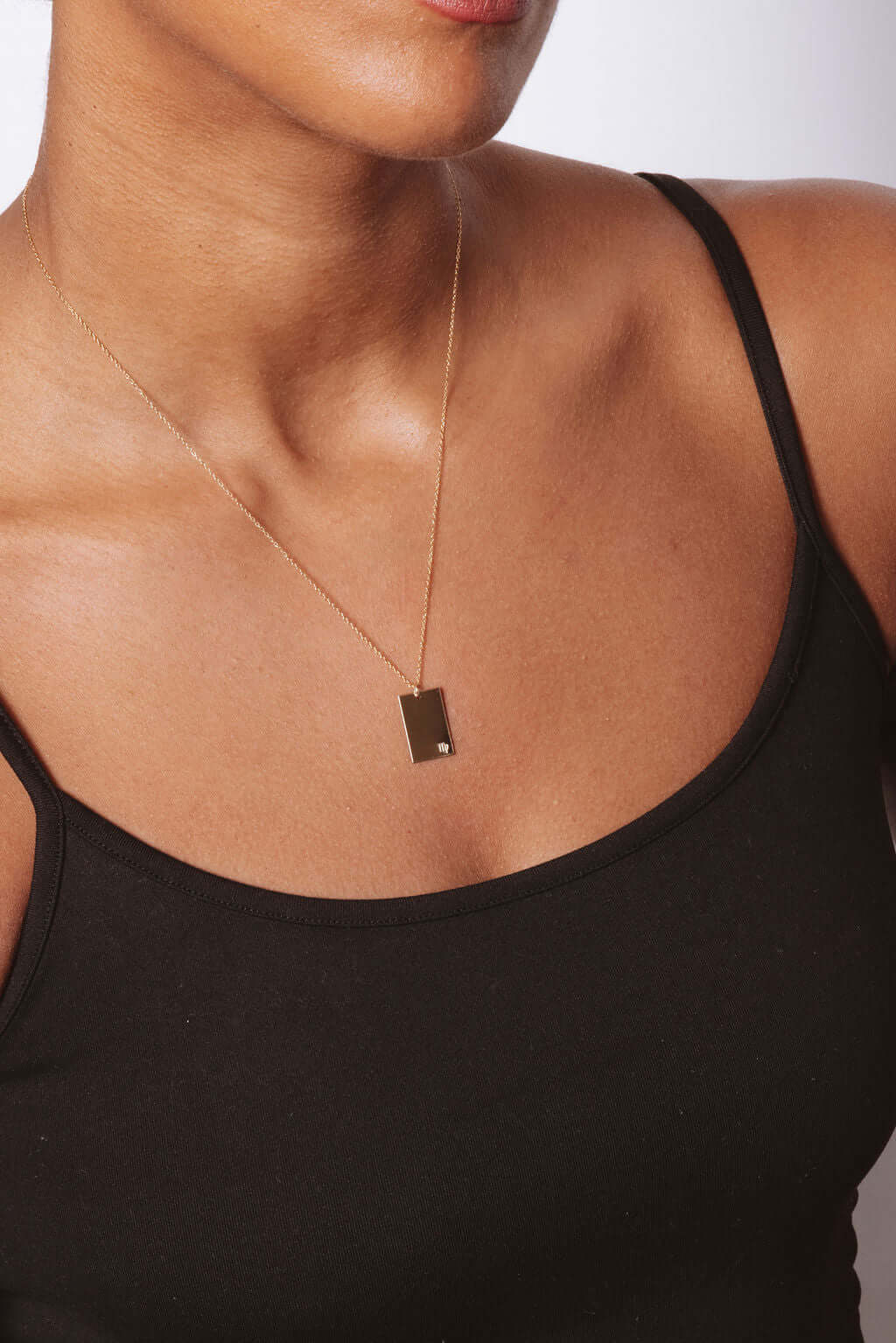 Goldie Horoscope Necklace – Hand-Stamped Zodiac in Gold-Filled worn elegantly on model with minimalist aesthetic.