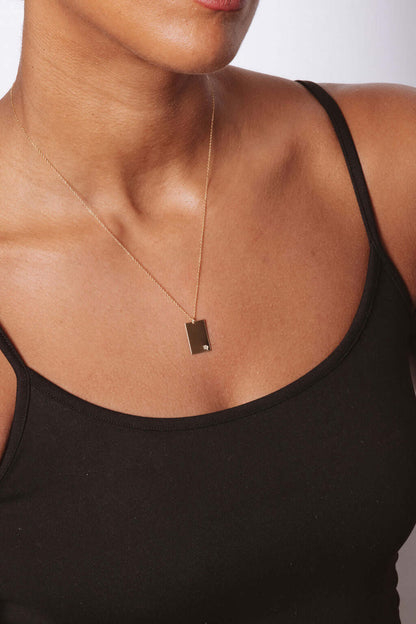 Goldie Horoscope Necklace – Hand-Stamped Zodiac in Gold-Filled worn elegantly on model with minimalist aesthetic.