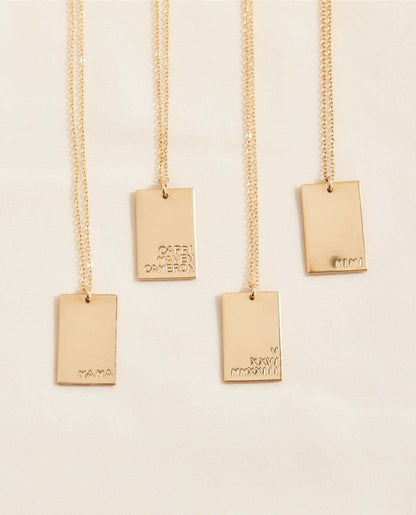 Goldie MAMA Necklace – Hand-Stamped 14k Gold-Filled Pendant showcasing four gold necklaces with engraved pendants.