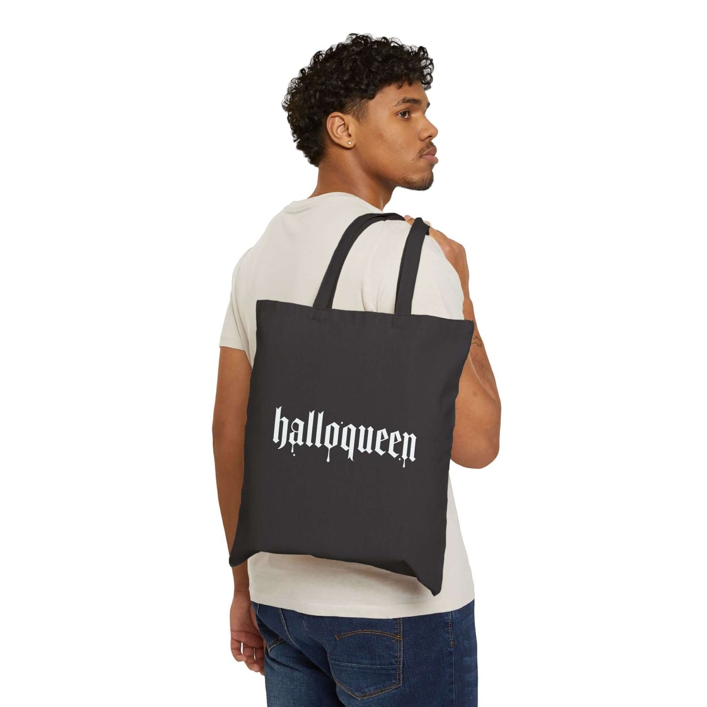 Double-Sided Halloween Tote – “Here for the Boos” + Spooky Vibes being modeled by a man with a playful design.