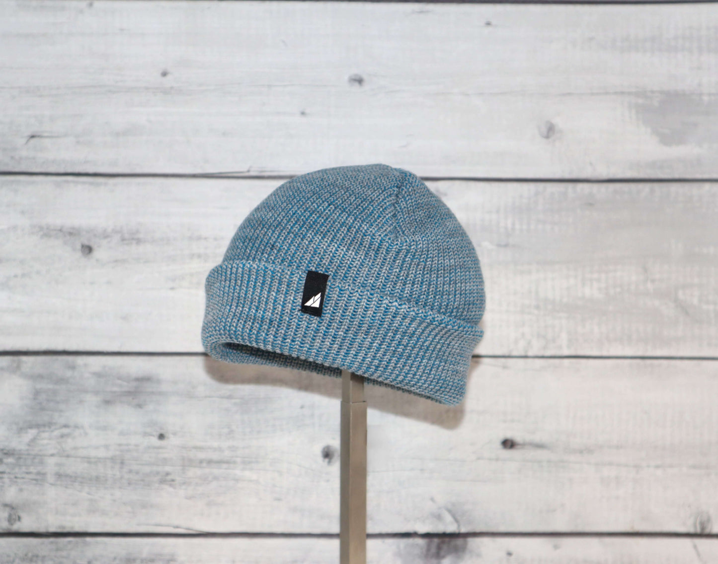 Infant Acrylic Cuff Hat – Soft Knit Beanie for Ages 3–12M in blue color on a wooden background.
