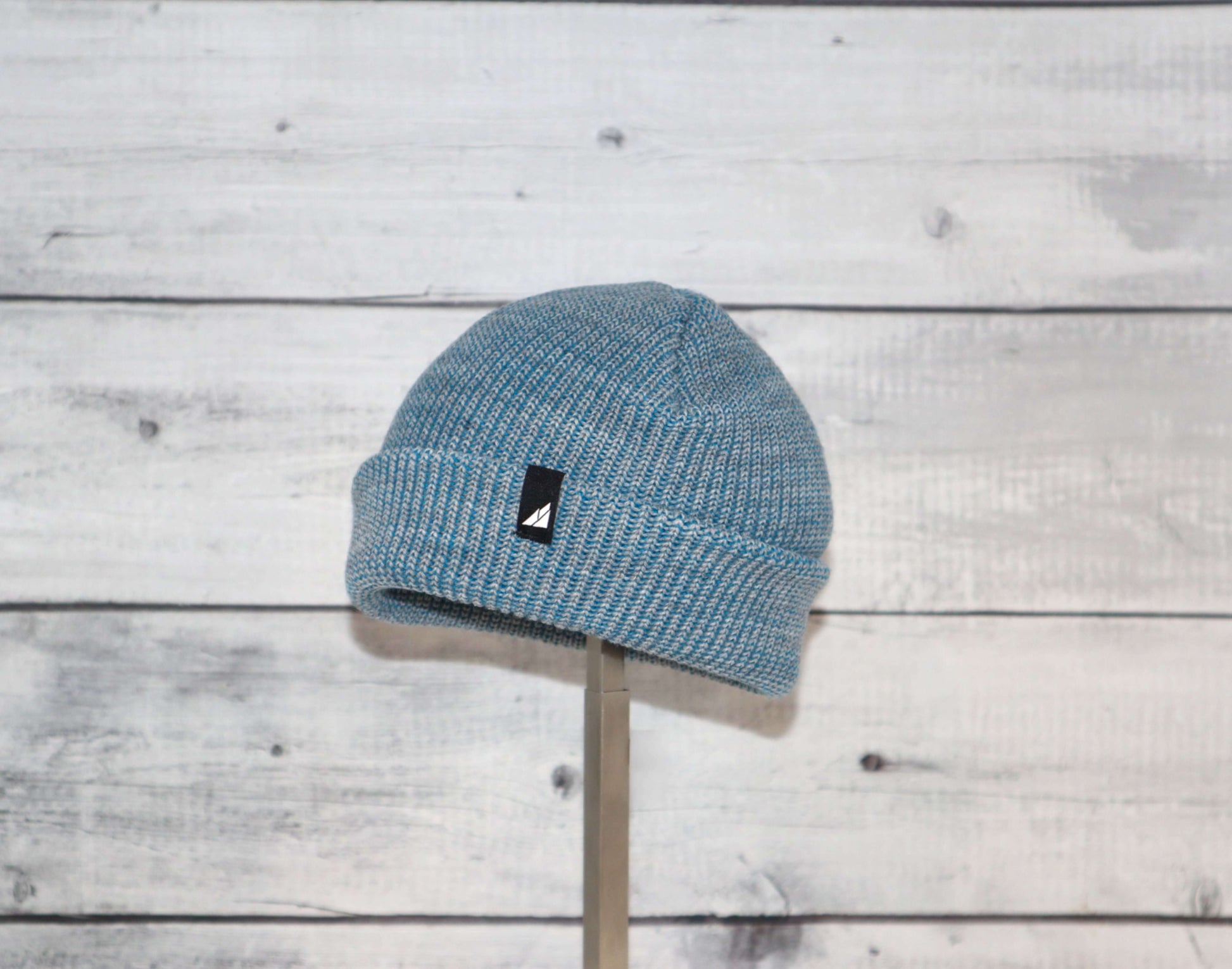 Infant Acrylic Cuff Hat – Soft Knit Beanie for Ages 3–12M in blue color on a wooden background.