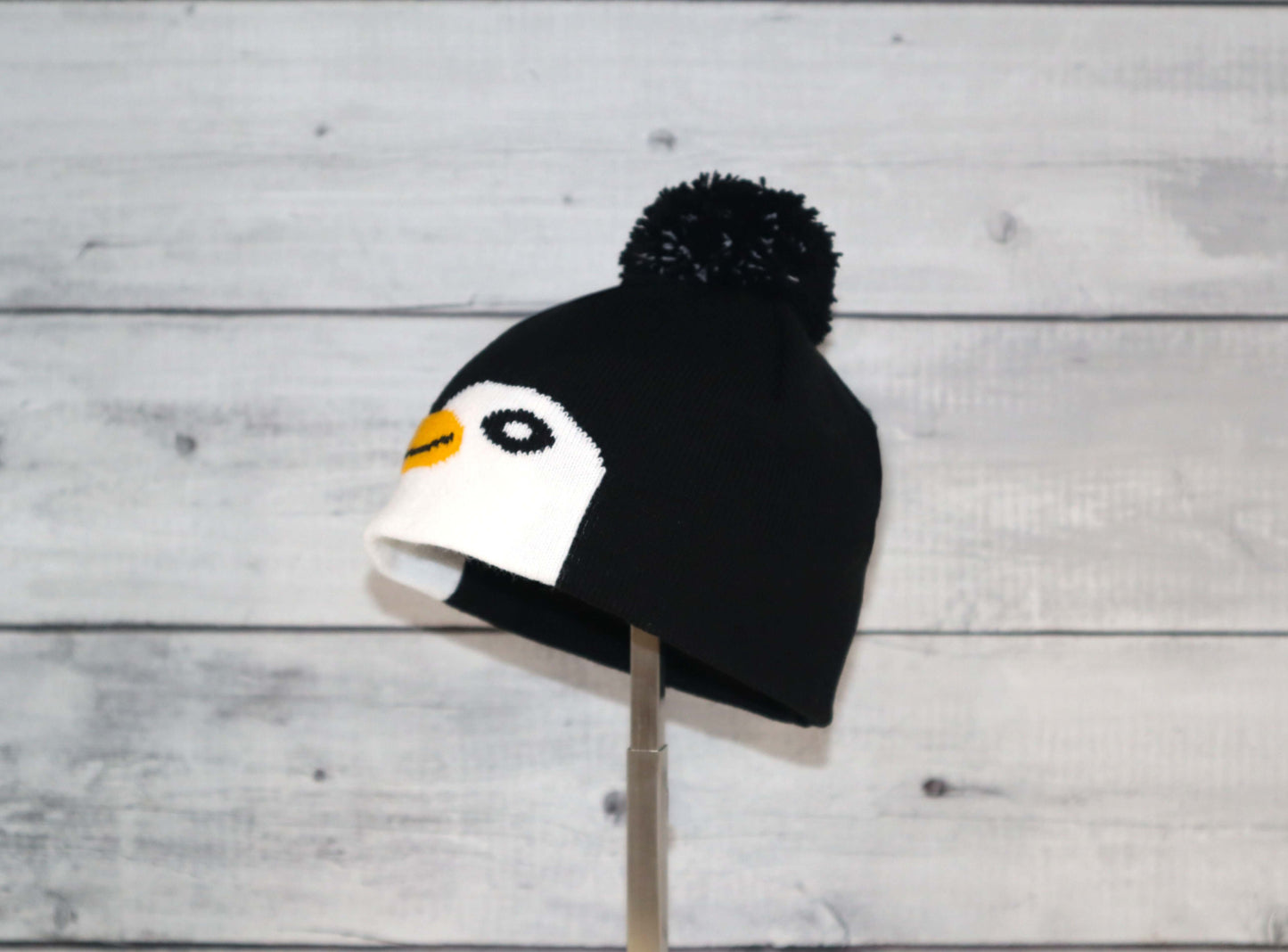 Infant Specialty Hat – Cozy, Playful, Purposeful featuring a cute penguin design with pom-pom.
