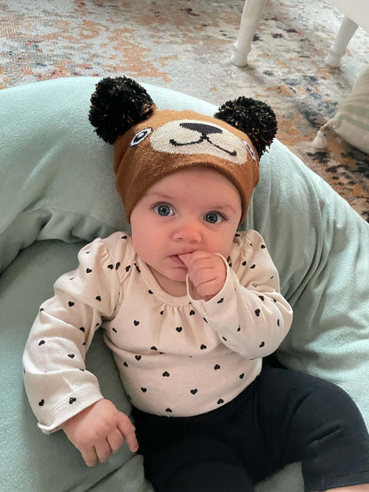 Infant Specialty Hat – Cozy, Playful, Purposeful, featuring a playful bear design on a baby.