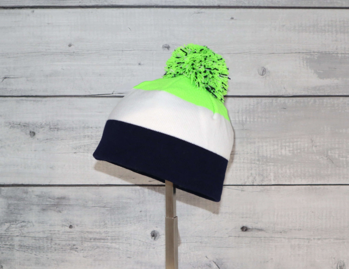 Infant Specialty Hat – Cozy, Playful, Purposeful in vibrant colors with a pom-pom, perfect for winter adventures.