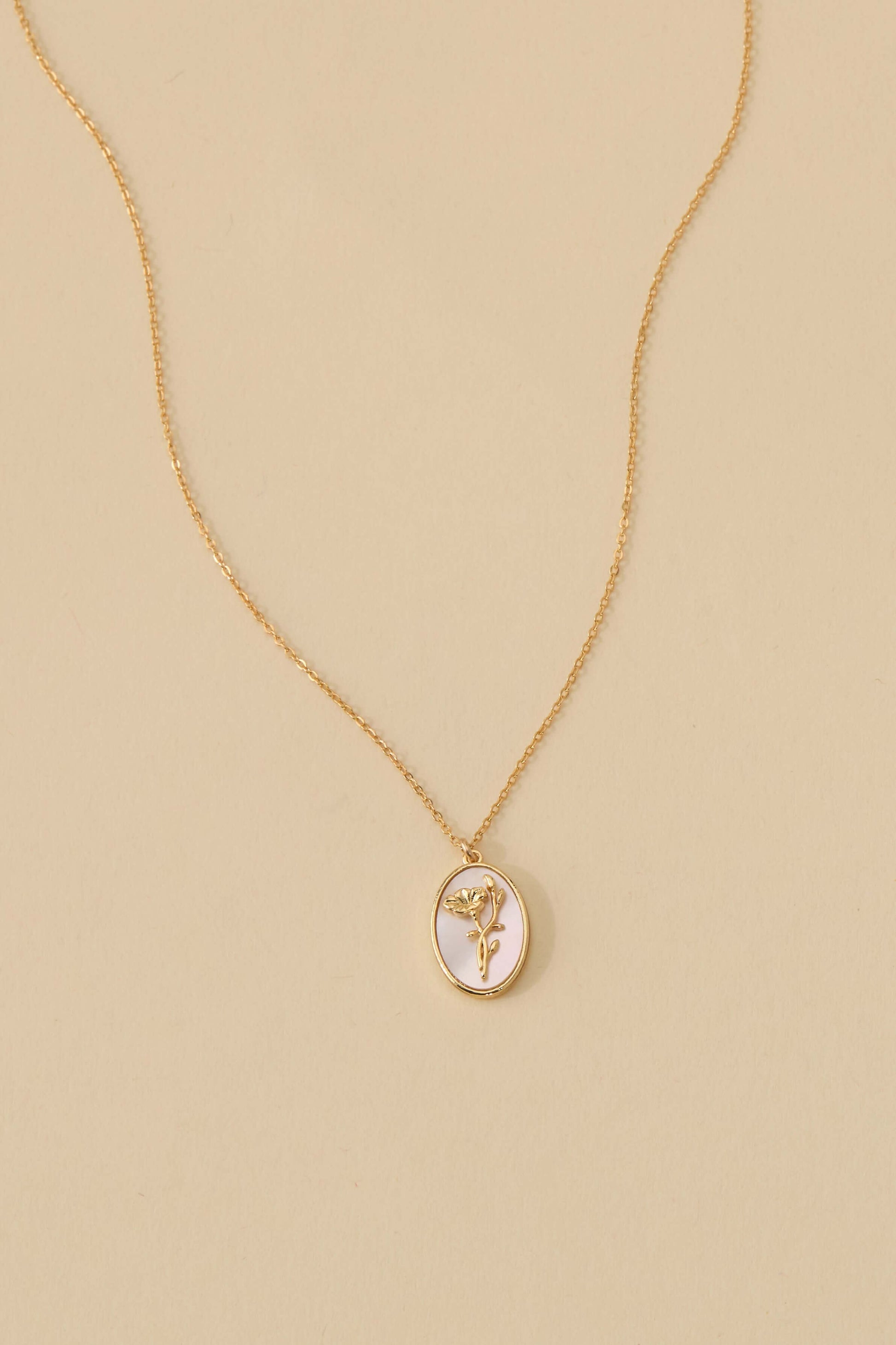 Katrina Birth Flower Necklace – Gold-Filled & Mother of Pearl, featuring an oval pendant with floral engraving.