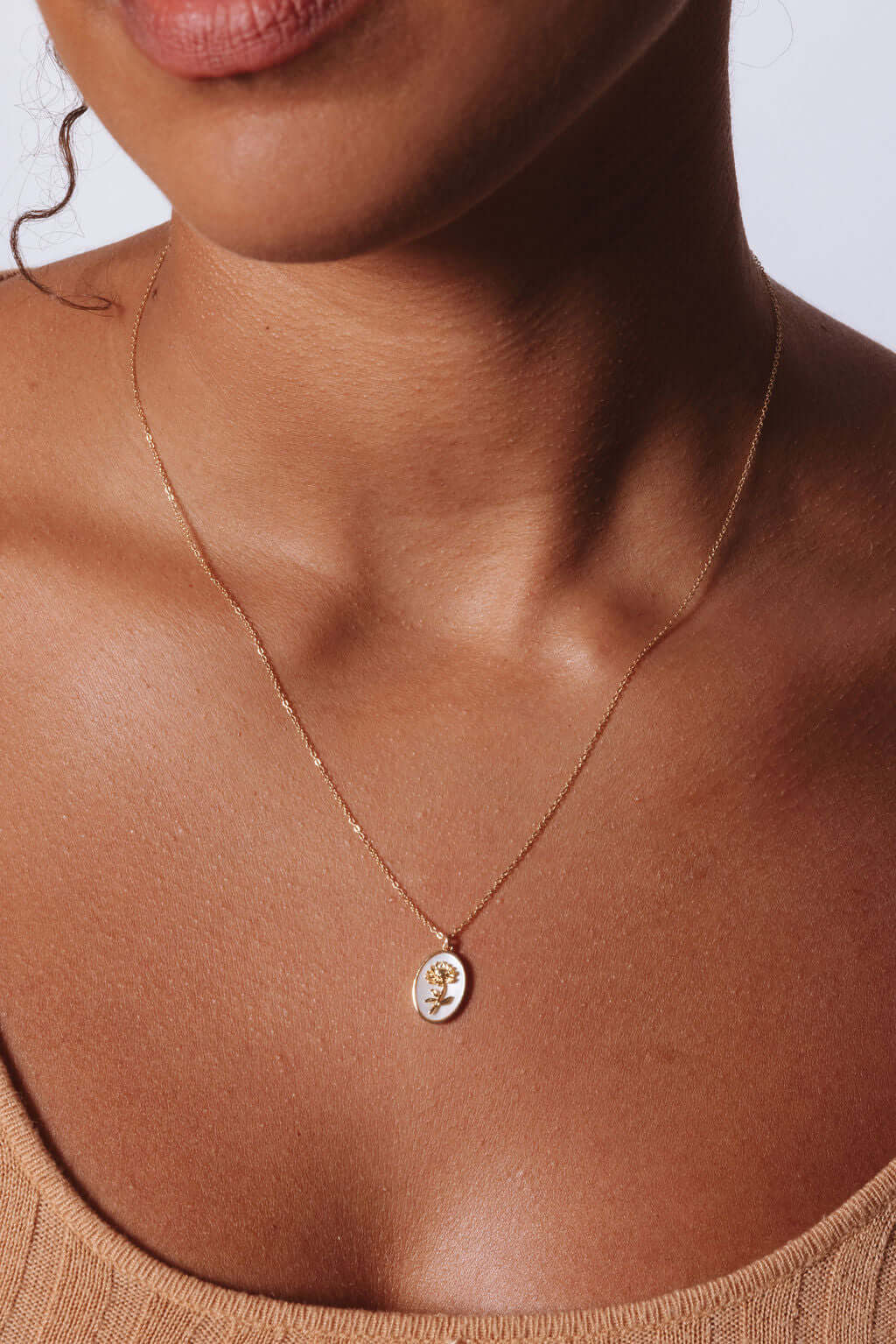 Model wearing Katrina Birth Flower Necklace – Gold-Filled & Mother of Pearl showcasing the elegant oval pendant.