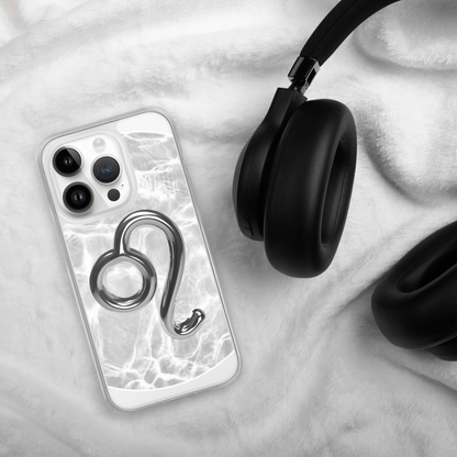 Zodiac Leo Magsafe clear iPhone case with marble design next to stylish headphones on soft fabric.
