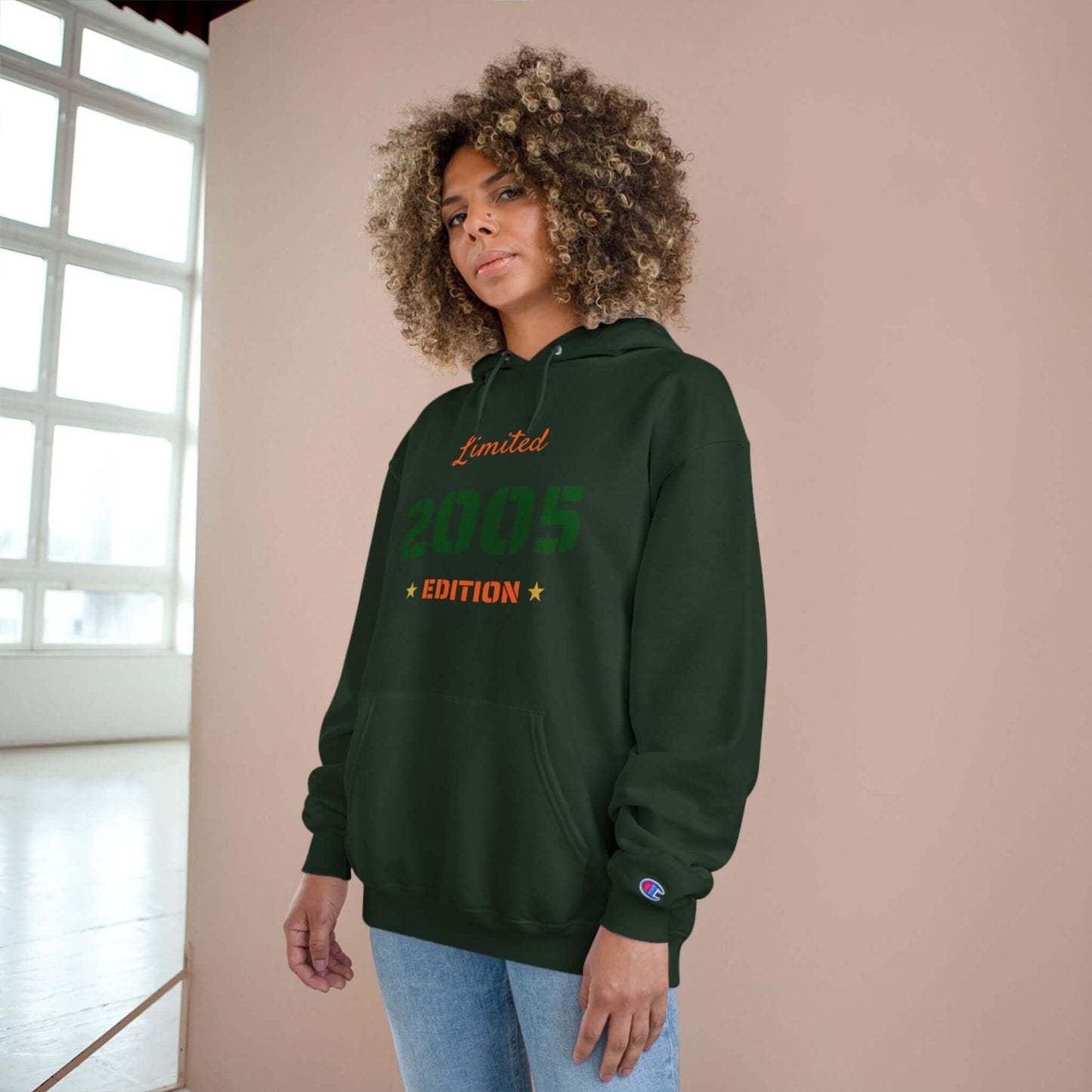 Limited Edition Year Hoodie – Champion Comfort, Collegiate Colors in dark green worn by young woman.