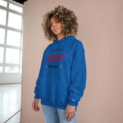 Limited Edition Year Hoodie – Champion Comfort, Collegiate Colors in blue worn by a model with curly hair.