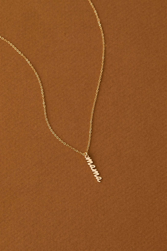 Mama Charm Necklace – 14k Gold-Filled Chain & Pendant on a warm brown background, highlighting its elegant design.