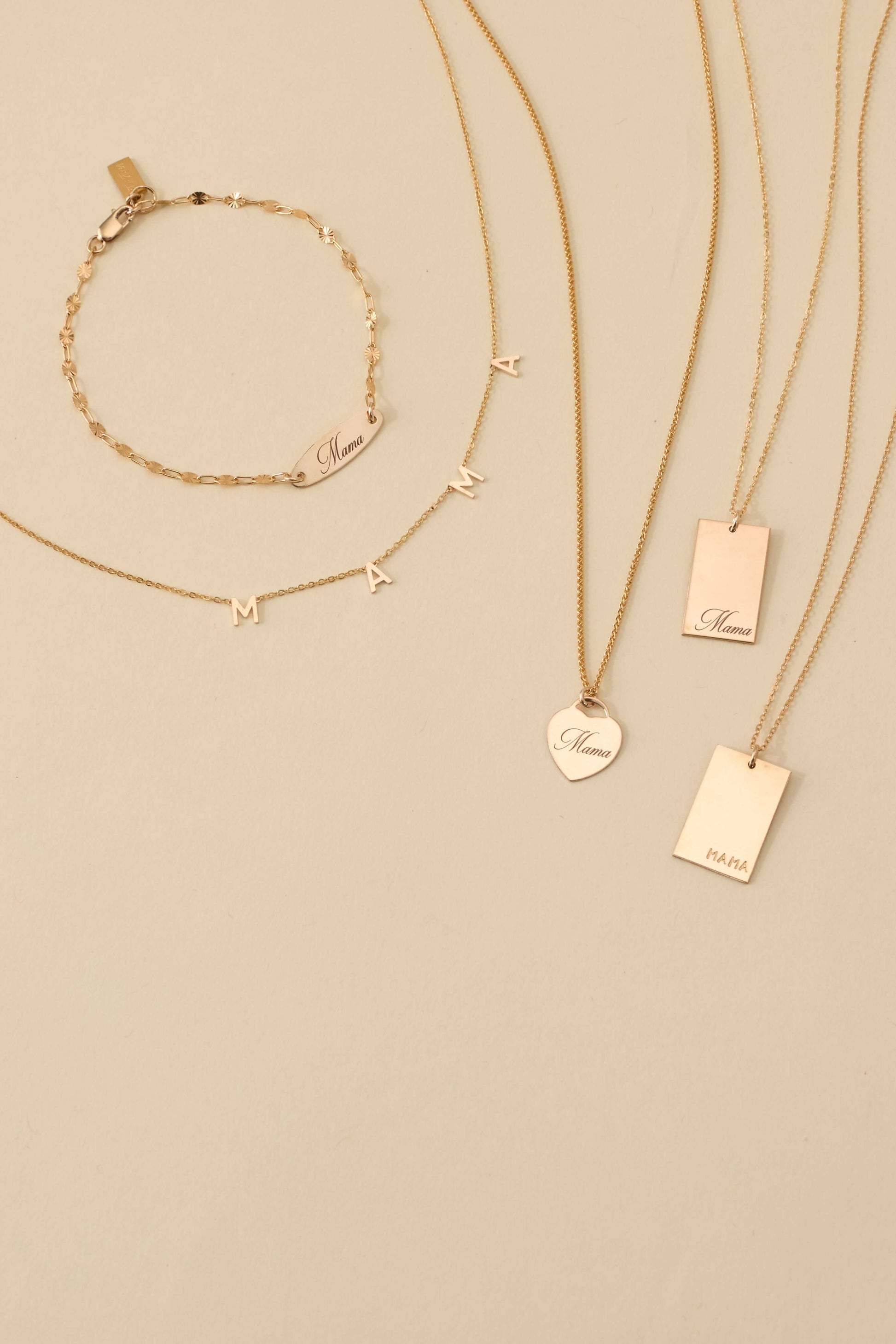 Mama Stella Necklace – 14k Gold-Filled Hand-Engraved Pendant displayed with other gold jewelry.