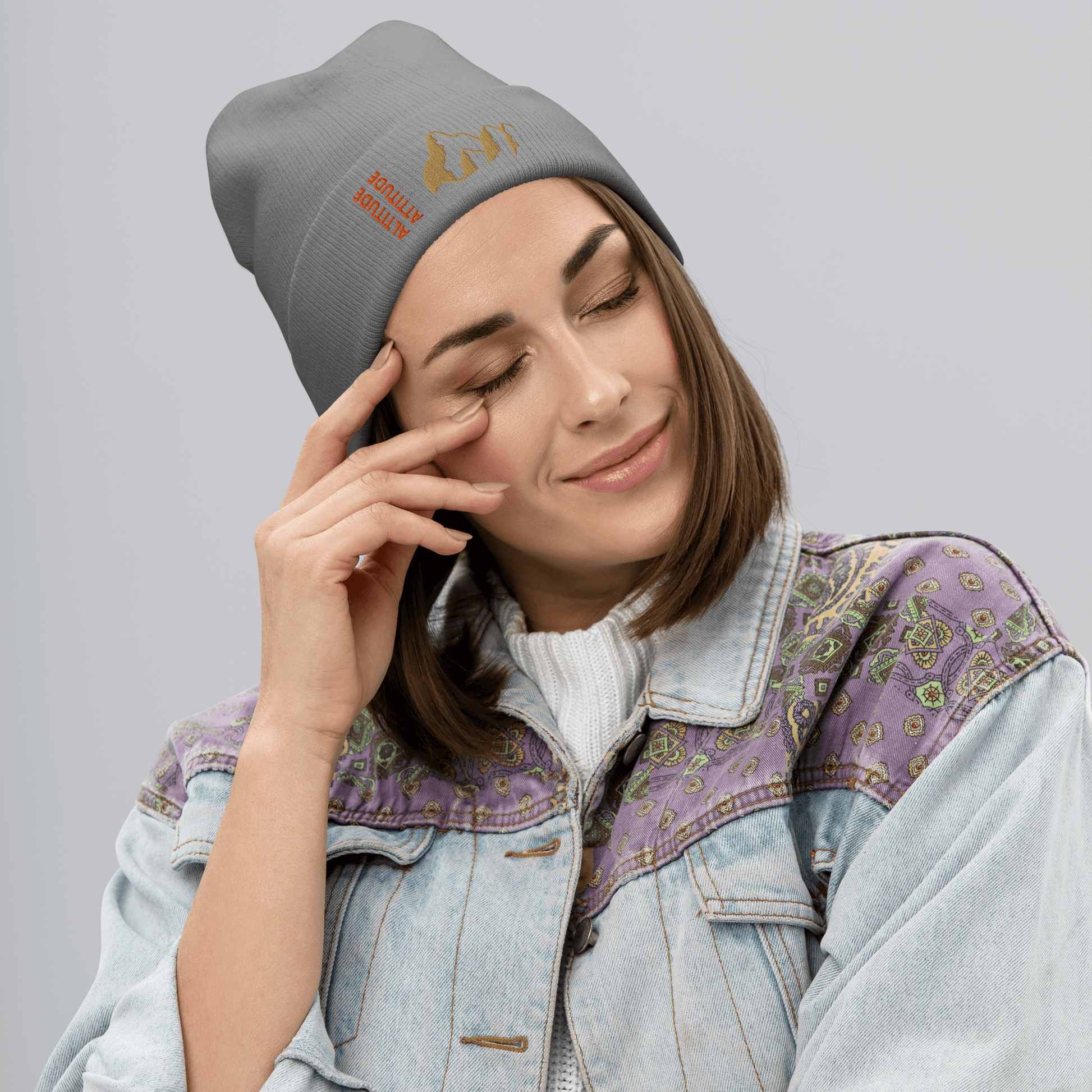 Mountain Beanie – Embroidered Knit Hat with Peak Style worn by a woman in a cozy outfit.