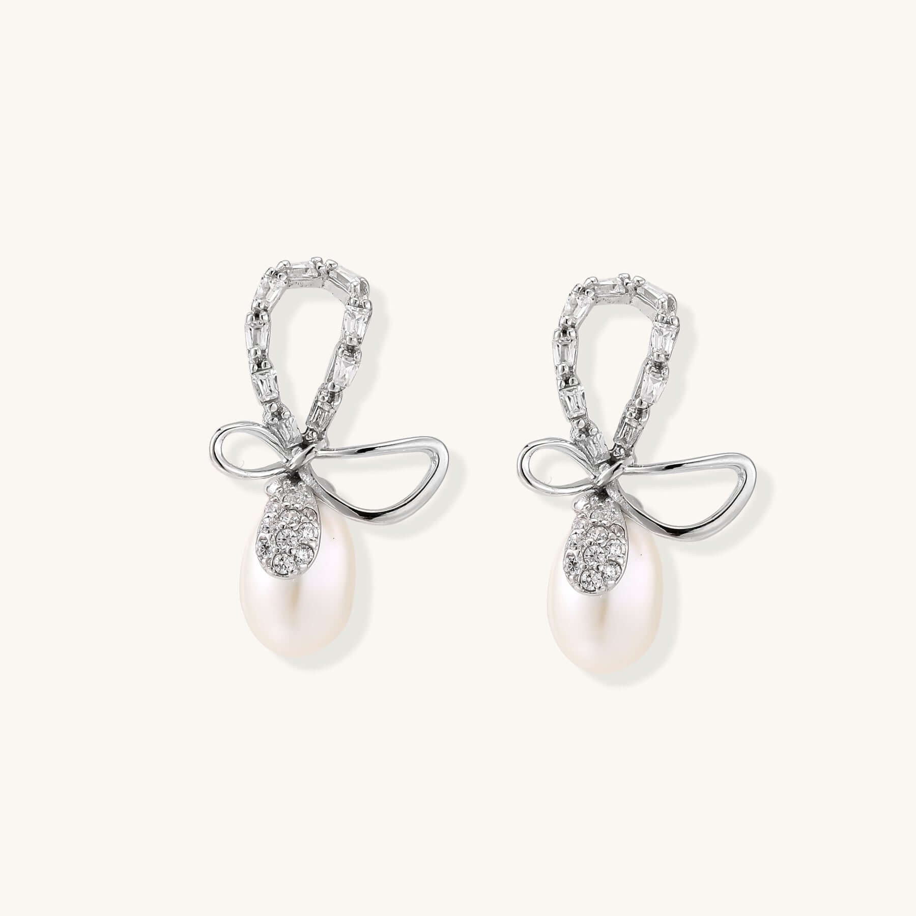 Pearl Drop Earrings with Crystal Bow Studs in Sterling Silver, featuring a bow stud and freshwater pearl.