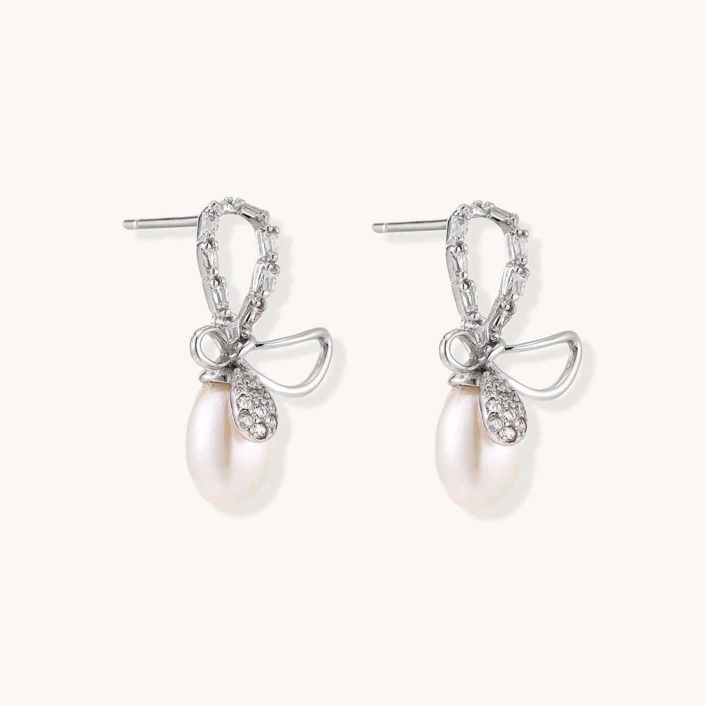 Pearl Drop Earrings with Crystal Bow Studs in Sterling Silver showcasing elegant design and luxurious freshwater pearls.
