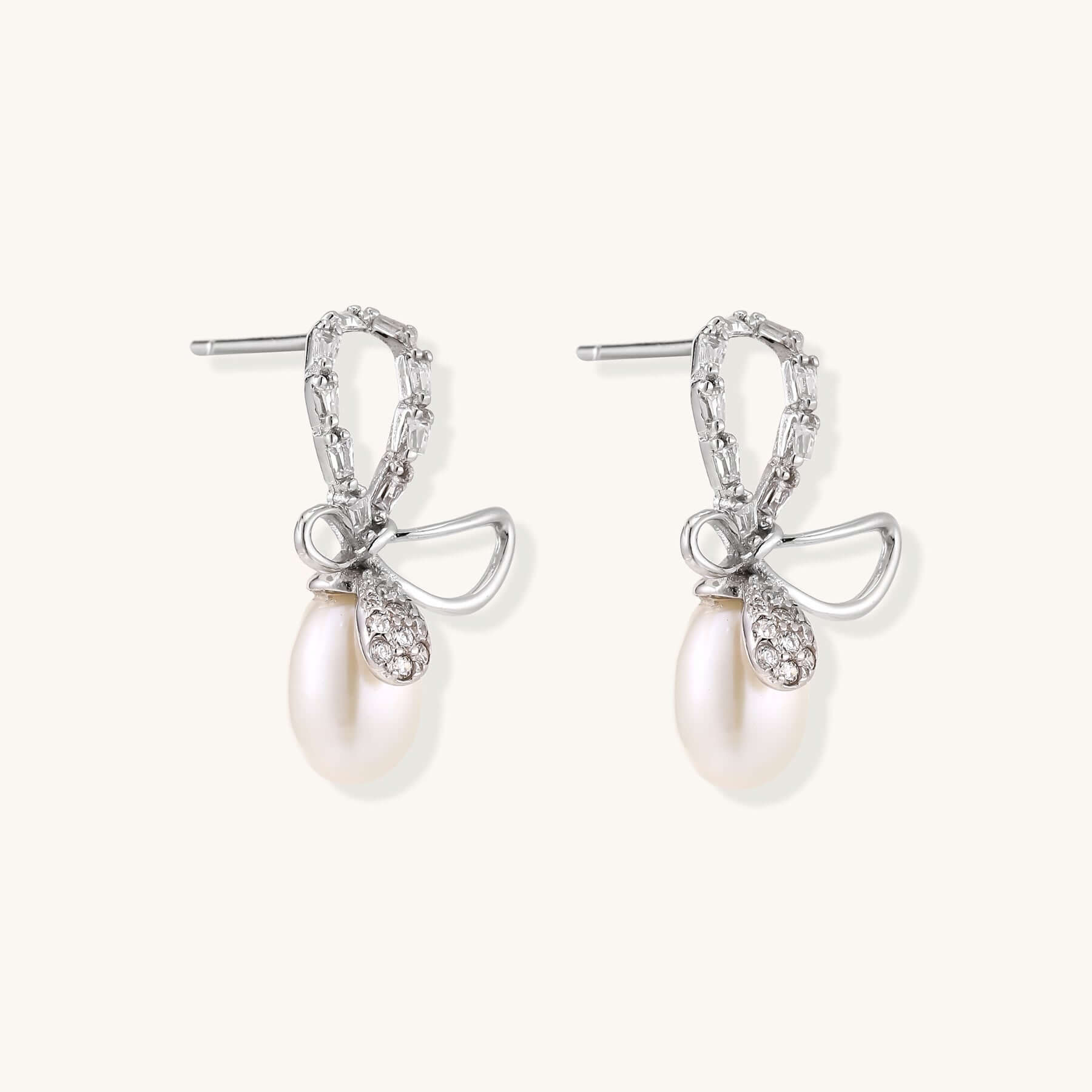 Pearl Drop Earrings with Crystal Bow Studs in Sterling Silver showcasing elegant design and luxurious freshwater pearls.