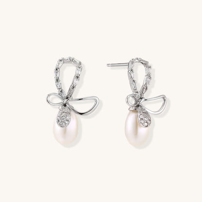 Pearl Drop Earrings with Crystal Bow Studs in Sterling Silver featuring luminous freshwater pearls and sparkling bow studs.