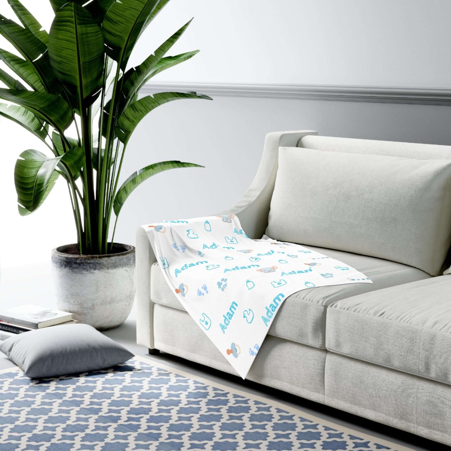 Personalized Baby Boy Blanket – Custom Swaddle with Name & Nursery Icons on a sofa, showcasing playful nursery designs.
