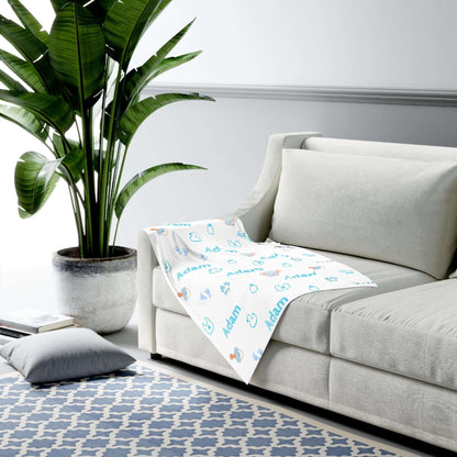 Personalized Baby Boy Blanket – Custom Swaddle with Name & Nursery Icons on a sofa, showcasing playful nursery designs.