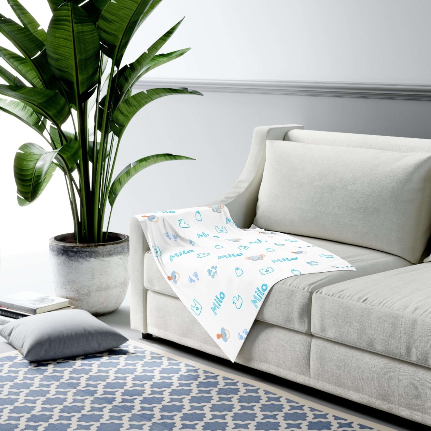 Personalized Baby Boy Blanket – Custom Swaddle with Name & Nursery Icons draped over a couch with vibrant nursery designs.