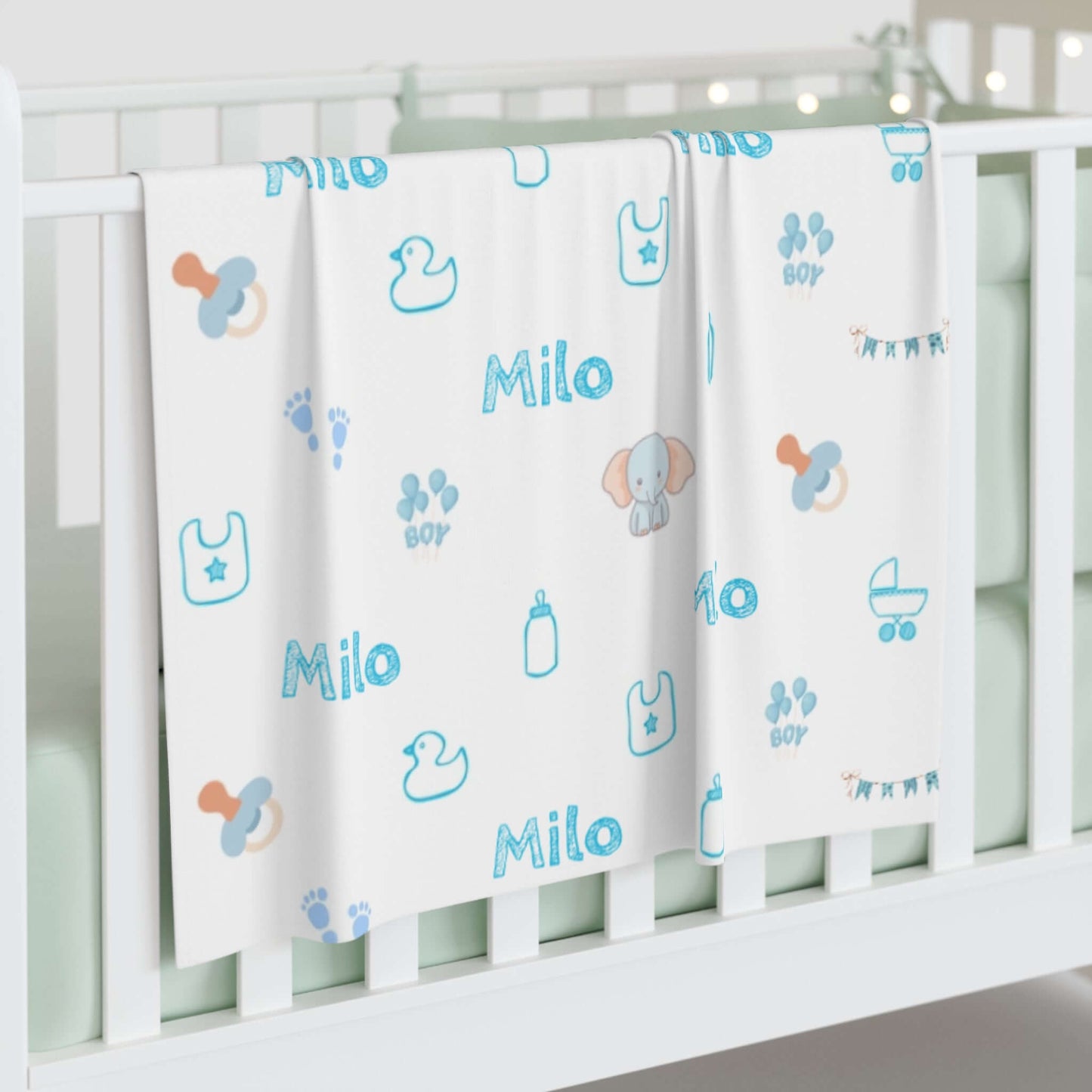Personalized Baby Boy Blanket – Custom Swaddle with Name & Nursery Icons displayed on crib with playful designs and name Milo.