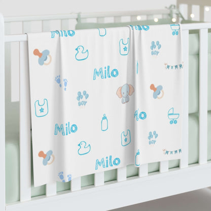 Personalized Baby Boy Blanket – Custom Swaddle with Name & Nursery Icons displayed on crib with playful designs and name Milo.