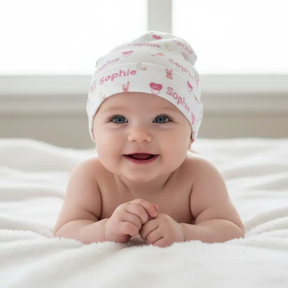Personalized Baby Girl Beanie – Custom Infant Hat with Name & Icons on a smiling baby girl.