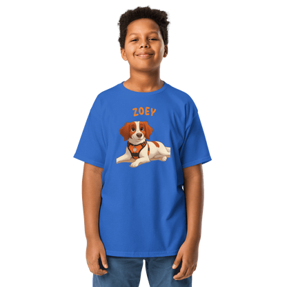 Boy wearing a blue personalized cartoon pet shirt featuring a dog illustration and the name 'Zoey'.