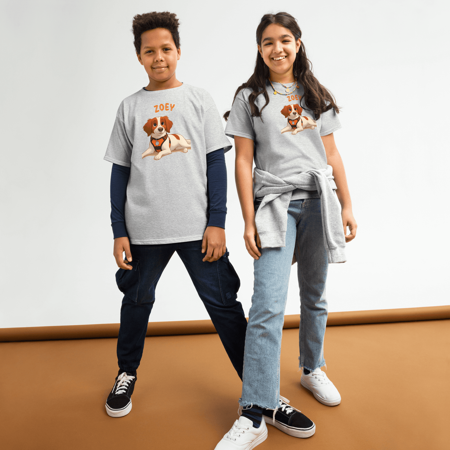 Two kids wearing personalized cartoon pet shirts, featuring a dog illustration and custom name 'Zoey'.