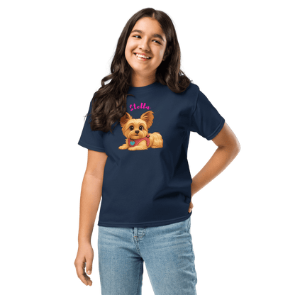 Girl wearing a navy shirt featuring a cartoon illustration of a Yorkie dog named Stella.