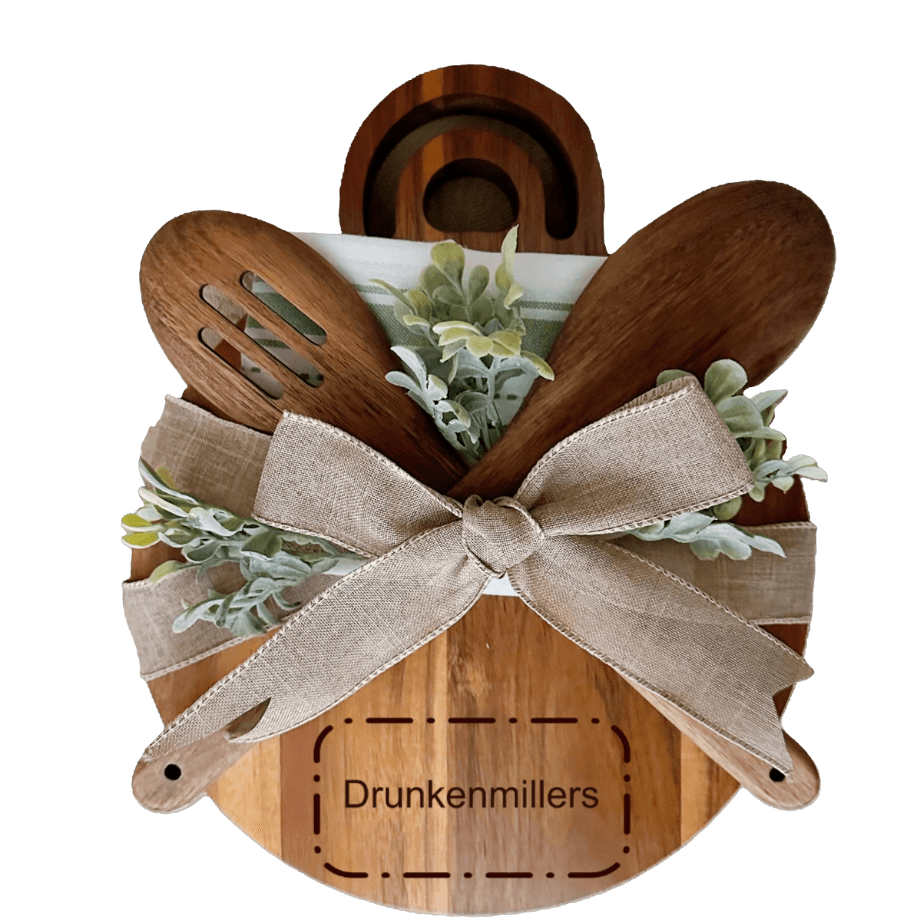 Personalized wooden cheese board with kitchen utensils and greenery, engraved with 'Drunkenmillers'.