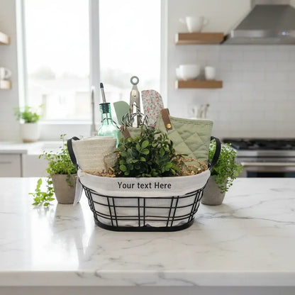Personalized Home Warming Gift Basket with Engraved Cutting Board arranged in a black wire frame on a kitchen counter.