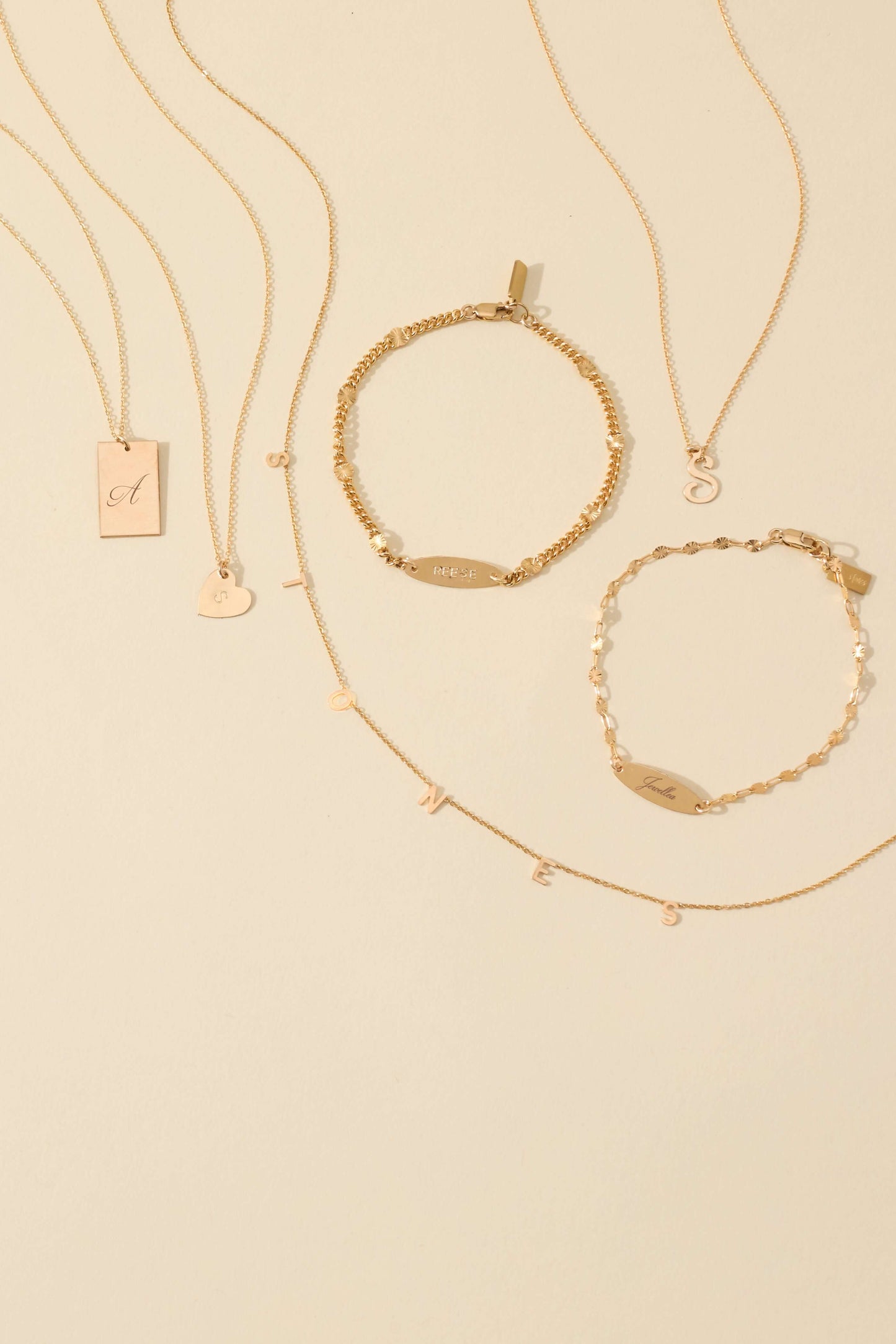 The First Layer – Personalized Sophia Initial Necklace in 14k Gold-Filled displayed with matching gold jewelry.