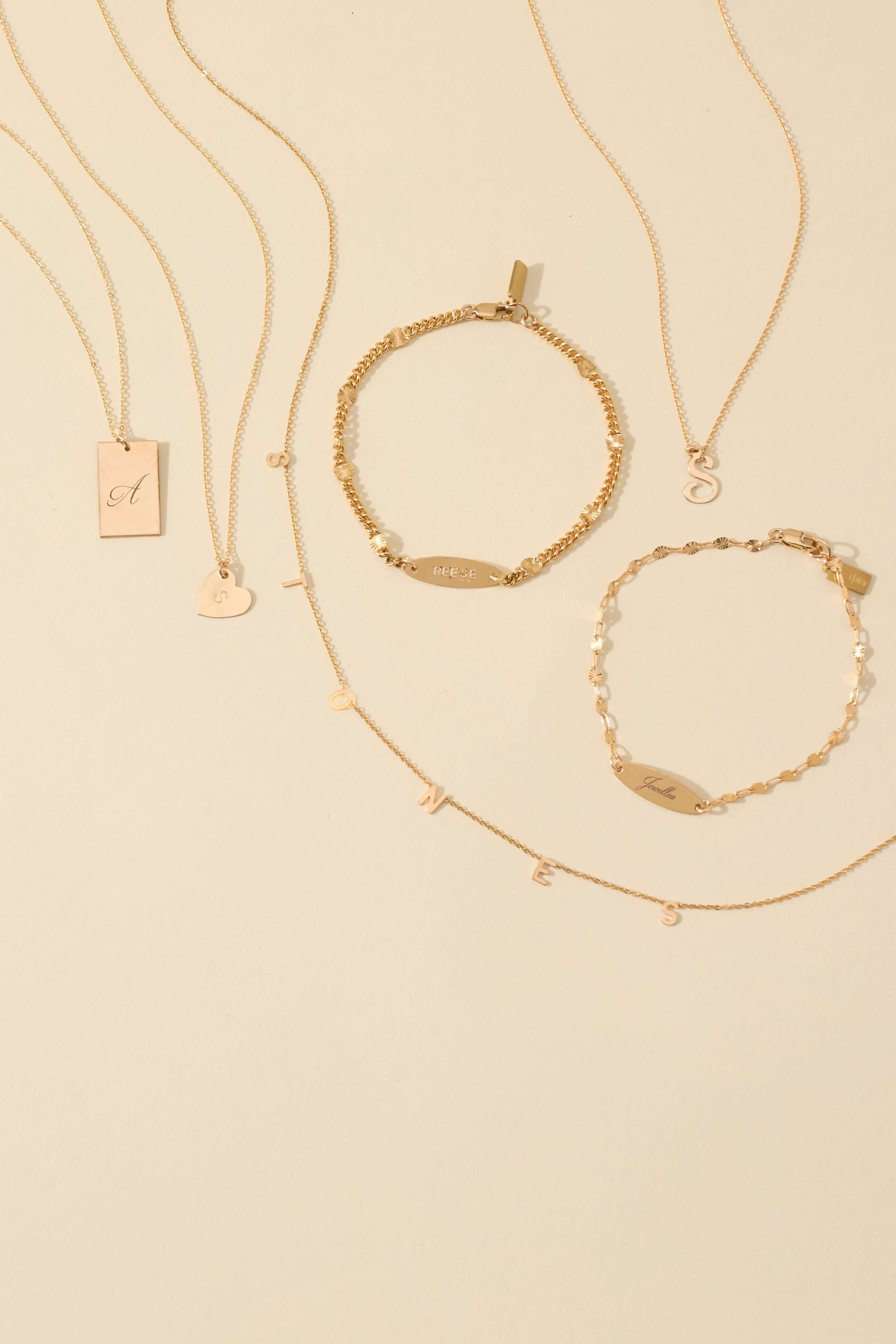 The First Layer – Personalized Sophia Initial Necklace in 14k Gold-Filled displayed with matching gold jewelry.