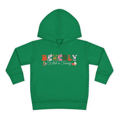Spooky Toddler Hoodie – Personalized Halloween Pullover for Your Little Boo in green with "Beverly Witch in Training" design.