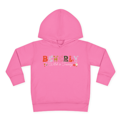 Spooky Toddler Hoodie – Personalized Halloween Pullover for Your Little Boo in pink with 'Beverly Witch in Training' design.
