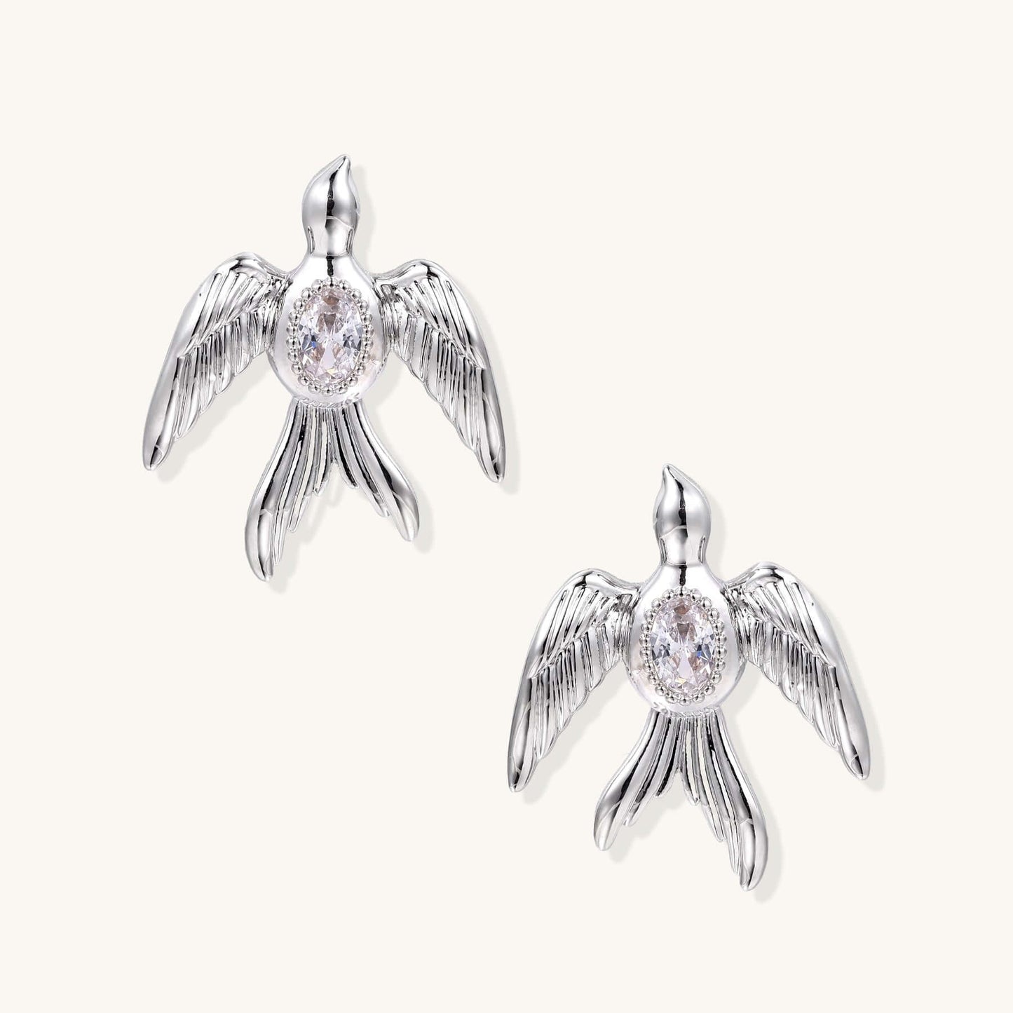 Phoenix Studs in silver-tone, featuring sculptural wings and shimmering zirconia accents.