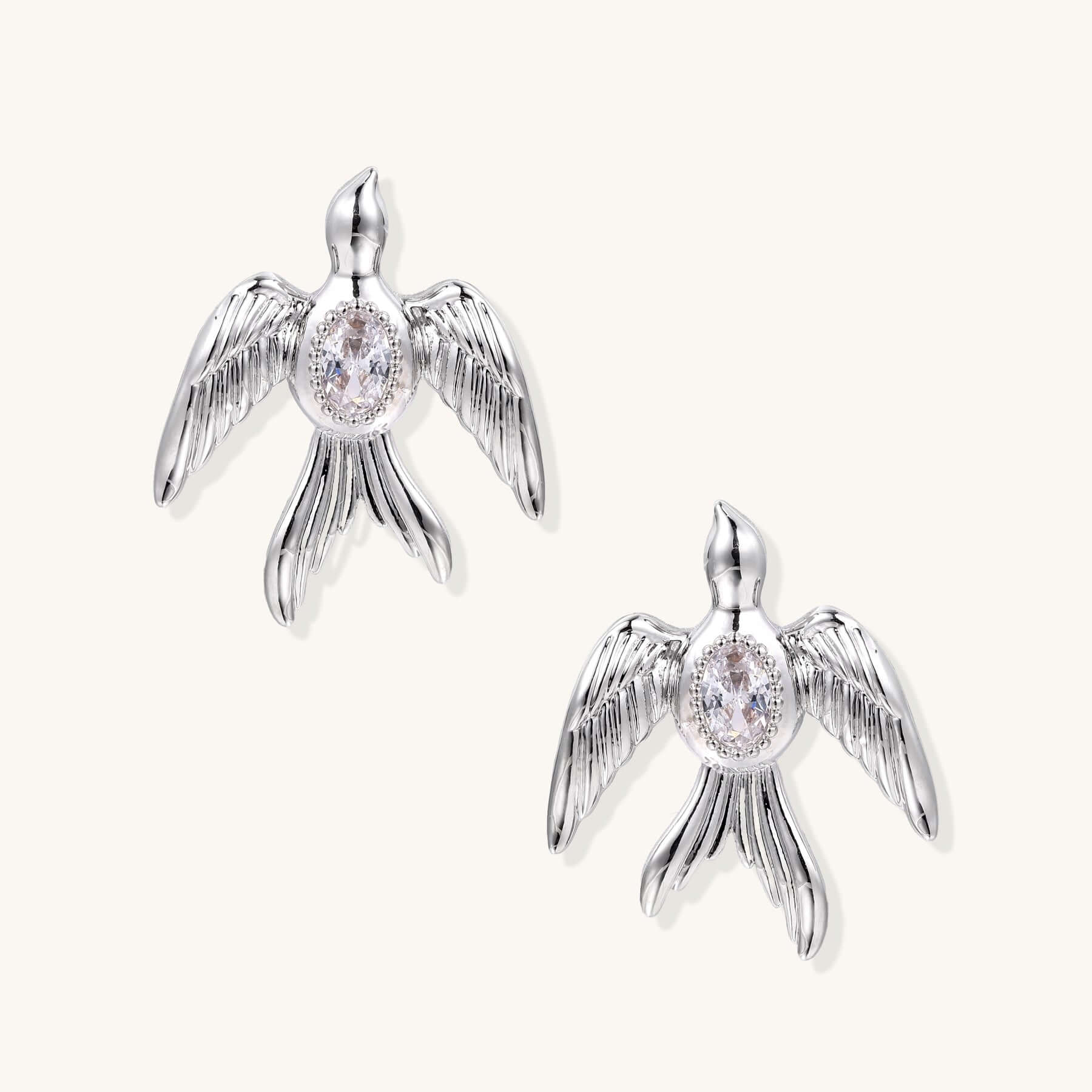 Phoenix Studs in silver-tone, featuring sculptural wings and shimmering zirconia accents.