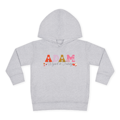 Spooky Toddler Hoodie – Personalized Halloween Pullover for Your Little Boo featuring the name Adam as a Wizard in Training.