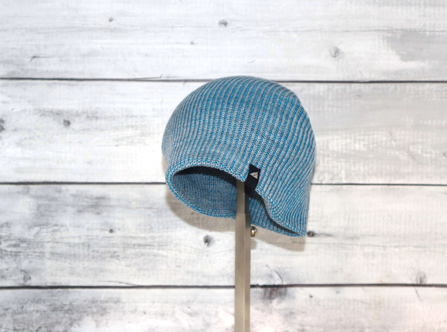 Toddler Acrylic Beanie – Soft Stretch Hat for Ages 1–3 in blue against wooden background.