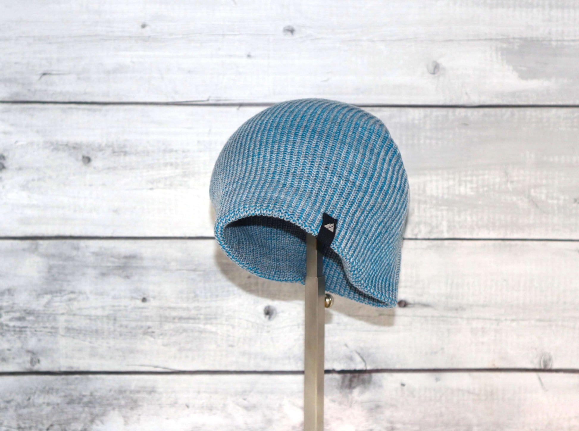 Toddler Acrylic Beanie – Soft Stretch Hat for Ages 1–3 in blue against wooden background.