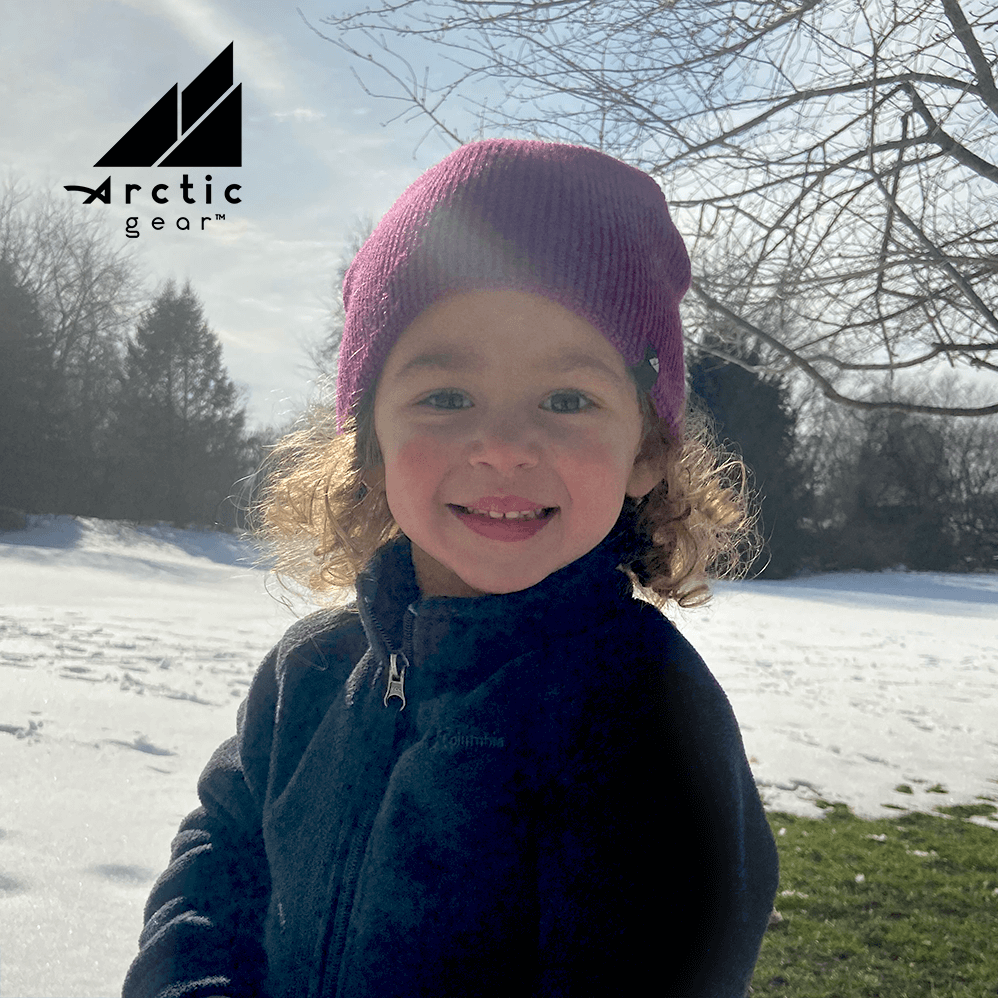 Toddler Acrylic Beanie – Soft Stretch Hat for Ages 1–3 worn by a smiling child in a snowy outdoor setting.