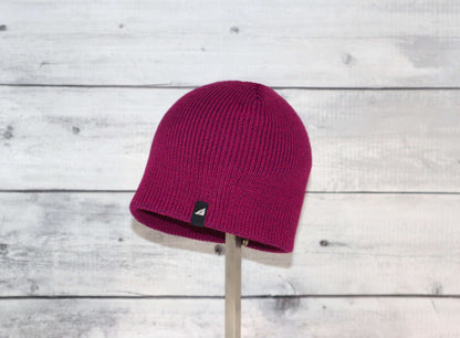 Toddler Acrylic Beanie – Soft Stretch Hat for Ages 1–3 in vibrant fuchsia color displayed on a wooden background.